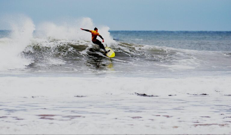 Surfer riding a breaking wave on a surfboard