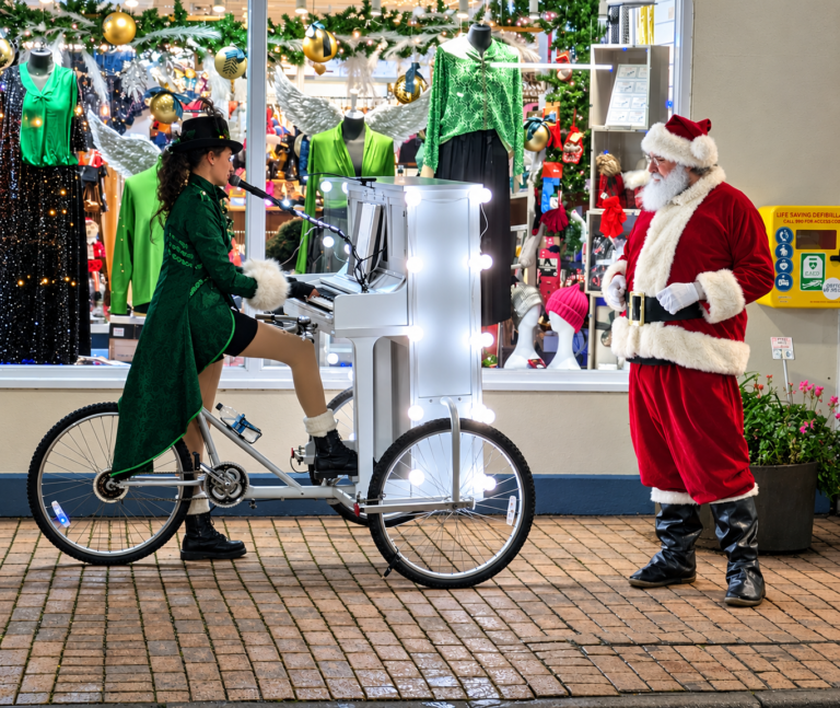 Photo of Ilfracombe's 'Piano Bike Girl' Chloe Aston meeting Santa